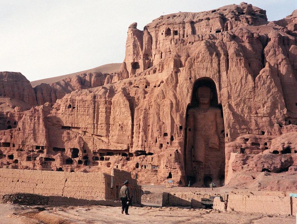 A file photo dated 07 December 1997 shows an Afghan walking near the world's tallest standing statue of Buddha in Bamiyan province of Afghanistan (AFP/Getty)