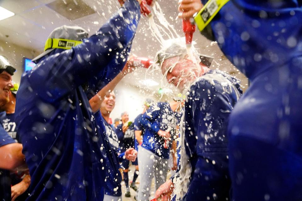 Dodgers players celebrate clinching the NL West title.