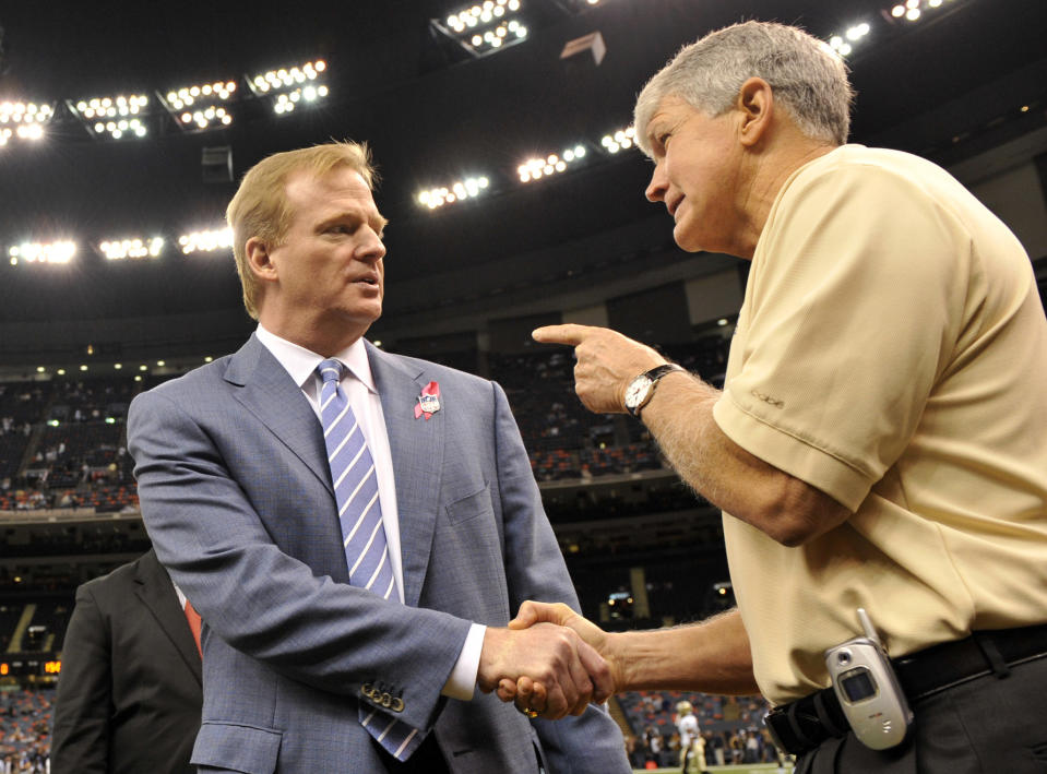 FILE - Former NFL coach Les Steckel, right, talks with NFL commissioner Roger Goodell prior to an NFL game between the New York Giants and New Orleans Saints in New Orleans, Sunday, Oct. 18, 2009. Luke Steckel is finishing up his 10th season working with the Tennessee Titans, the very same NFL team that made its lone Super Bowl appearance with his father Les as offensive coordinator. That connection didn't get Luke Steckel into the family business of the NFL. (AP Photo/Bill Feig, File)