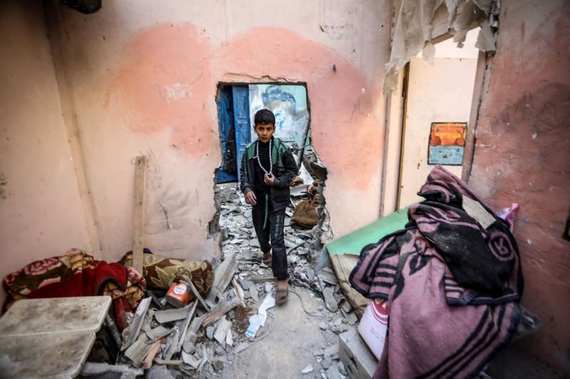 A Palestinian boy walks amid a damaged house after an Israeli strike in Rafah in the southern Gaza Strip on Wednesday. Photo by Ismael Mohamad/UPI