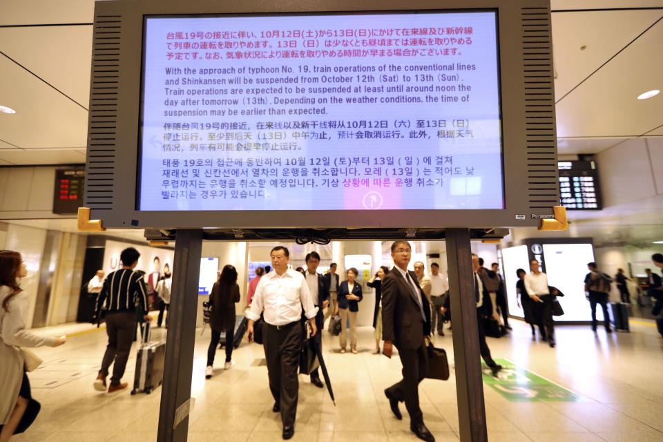 An electric board shows a notice on suspending operations of the Shinkansen or bullet train on Oct. 12-13 due to Typhoon Hagibis, at Tokyo Station in Tokyo Friday, Oct. 11, 2019. Japan's weather agency is warning a powerful typhoon may bring torrential rains to central Japan over the weekend. (AP Photo/Eugene Hoshiko)