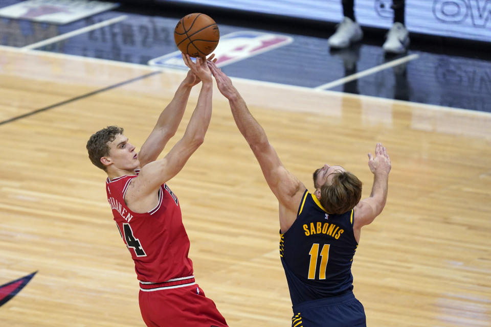 Chicago Bulls' Lauri Markkanen, left, shoots over Indiana Pacers' Domantas Sabonis during the first half of an NBA basketball game Saturday, Dec. 26, 2020, in Chicago. (AP Photo/Charles Rex Arbogast)