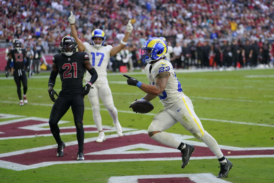 Los Angeles Rams running back Kyren Williams, right, scores a touchdown during the first half of an NFL football game against the Arizona Cardinals, Sunday, Nov. 26, 2023, in Glendale, Ariz. (AP Photo/Matt York)