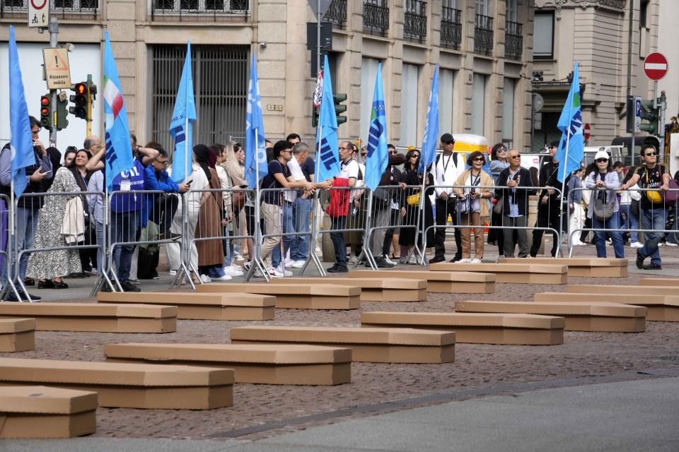 La Scala theatre square is filled with 172 coffins, as many as the number of deaths at work that Lombardy recorded in 2023, during a flash mob organised by UIL trade union organization, in Milan, Italy, Friday, May 10, 2024. (AP Photo/Luca Bruno)