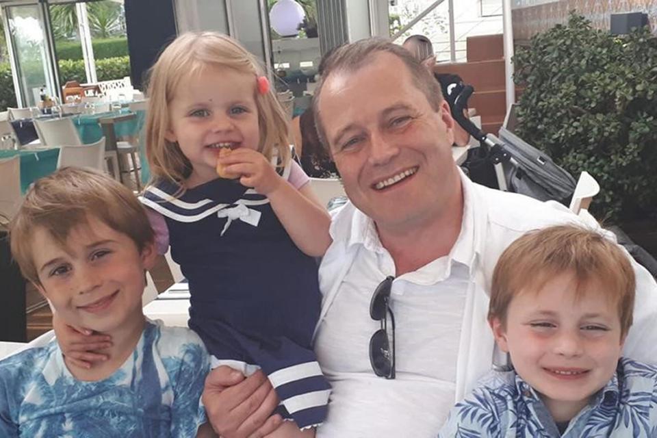 Conor McGinley, 9, Darragh McGinley, 7, and Carla McGinley, 3, with their father Andrew McGinley (PA Media)