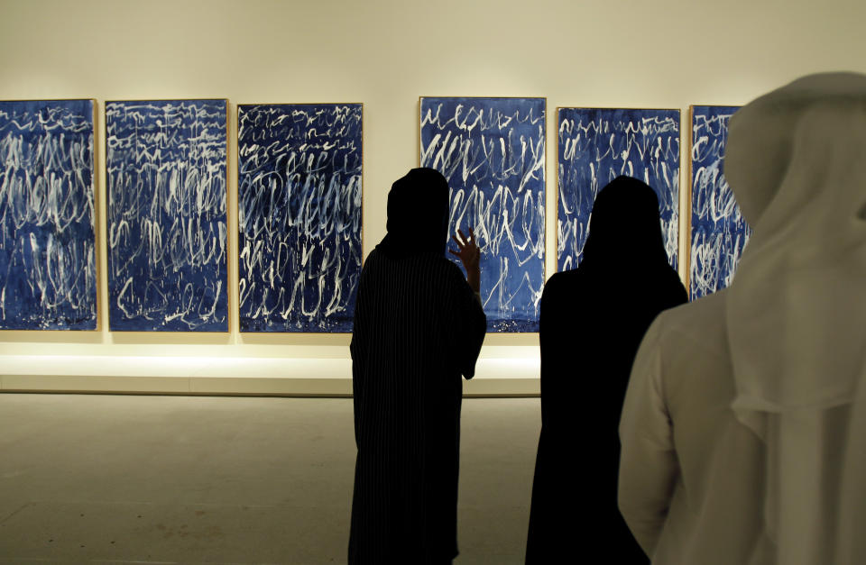 An Emirati guide describes an untitled piece by American artist Cy Twombly which is part of a sample collection at the Abu Dhabi branch of the Louvre in Abu Dhabi, United Arab Emirates, Tuesday, April 16, 2013. No artistic subjects will be off limits at the Abu Dhabi branch of the Louvre museum as it builds its collection for a planned 2015 opening, a top overseer said Tuesday, in a city seeking to broaden its international profile but testing how far to open its conservative culture. (AP Photo/Kamran Jebreili)