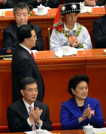 Chinese President Hu Jintao (L) walks by Liu Yandong (bottom R), the only female in the more senior 25-member Politburo, during the opening session of the Communist Party Congress at the Great Hall of the People in Beijing