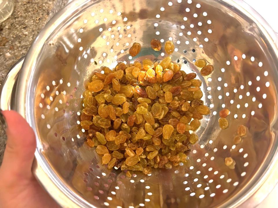 Draining raisins for Ina Garten's Apple Spice Cake