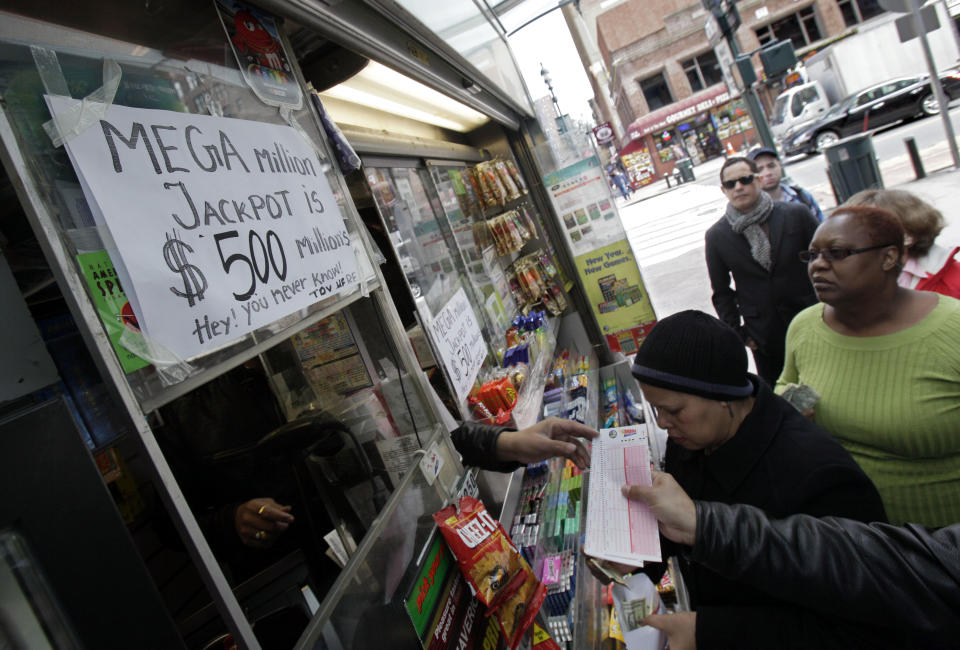 Mega Millions lottery contestants queue up for tickets for Friday's $500-million game at a corner newsstand in New York,  Thursday, March 29, 2012.  Forget setting up a charity or establishing a trust, the winner of the $500 million Mega Millions jackpot could save teachers' jobs or help pay for Medicaid-funded doctor appointments in their home state just by paying taxes. (AP Photo/Richard Drew)