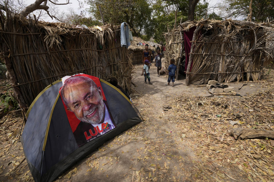 A towel emblazoned with an image of Brazil's former President Luiz Inacio Lula da Silva, who is running for reelection, is draped over a tent during the culmination of the week-long pilgrimage and celebration for the patron saint "Nossa Senhora da Abadia" or Our Lady of Abadia, in the rural area of Cavalcante in Goias state, Brazil, Saturday, Aug. 13, 2022. Devotees celebrate Our Lady of Abadia at this time of the year with weddings, baptisms and by crowning distinguished community members, as they maintain cultural practices originating from Africa that mix with Catholic traditions. (AP Photo/Eraldo Peres)