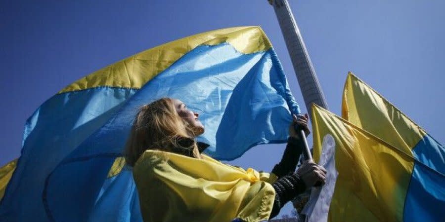 A woman waves the Ukrainian flag