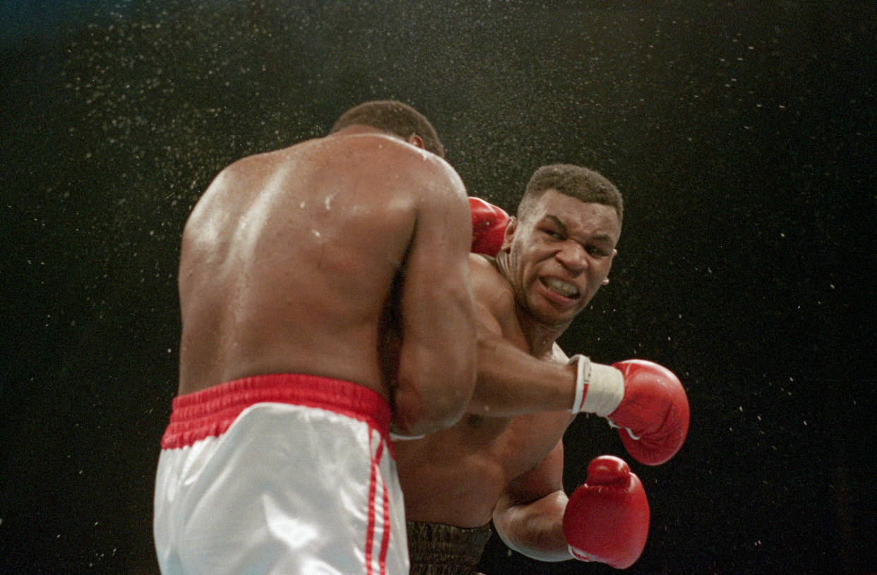 (Original Caption) 1/22/1988-Atlantic City, NJ Ferocious faced Mike Tyson lands the knockout punch to the jaw of challenger Larry Holmes during fourth round of the World Heavyweight Championship.