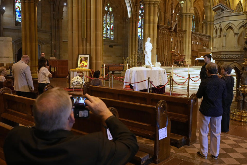 The coffin of Cardinal George Pell lays in state at St. Mary's Cathedral in Sydney, Wednesday, Feb. 1, 2023. Mourners paid their respects to Cardinal George Pell who lay in state in a Sydney cathedral on Wednesday as police sought a court order to prevent protesters from disrupting his funeral. (AP Photo/Rick Rycroft, Pool)