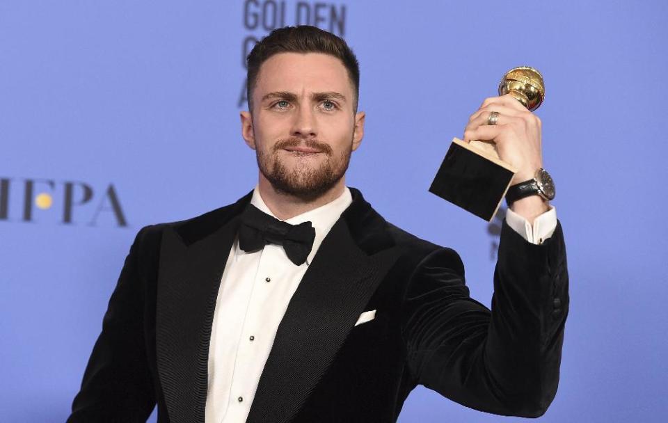 Aaron Taylor Johnson poses in the press room with the award for best performance by an actor in a supporting role in any motion picture for 