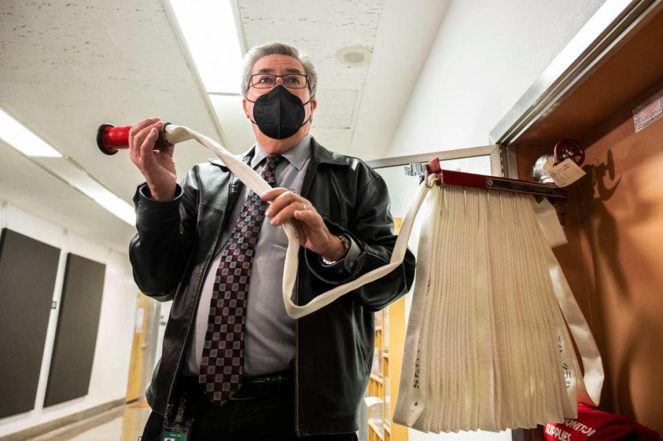 Assemblyman Ken Cooley, chair of the Joint Rules Committee holds a fire hose in the California State Capitol annex which he said is an example of outdated technology in the building. Cooley gave members of the press a tour of the old annex and the new Swing Space building on Wednesday.