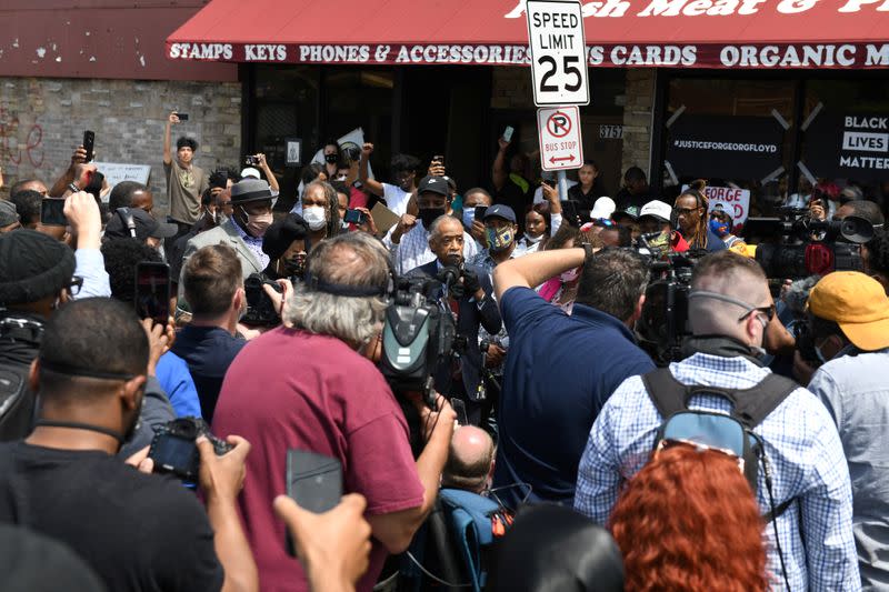 Civil rights activist Reverend Al Sharpton and Gwen Carr, mother of Eric Garner, lead a prayer at the site where African-American man George Floyd was fatally injured by police in Minneapolis