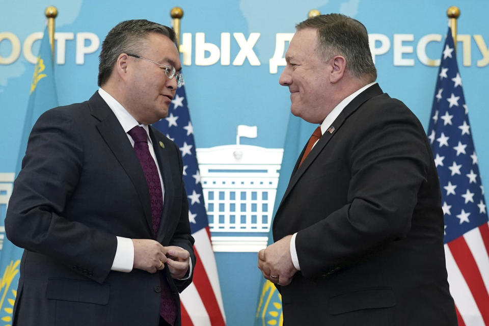 U.S. Secretary of State Mike Pompeo, right, buttons his jacket after holding a joint news conference with Kazakh Foreign Minister Mukhtar Tleuberdi at the Ministry of Foreign Affairs in Nur-Sultan, Kazakhstan, Sunday, Feb. 2, 2020. (Kevin Lamarque/Pool Photo via AP)