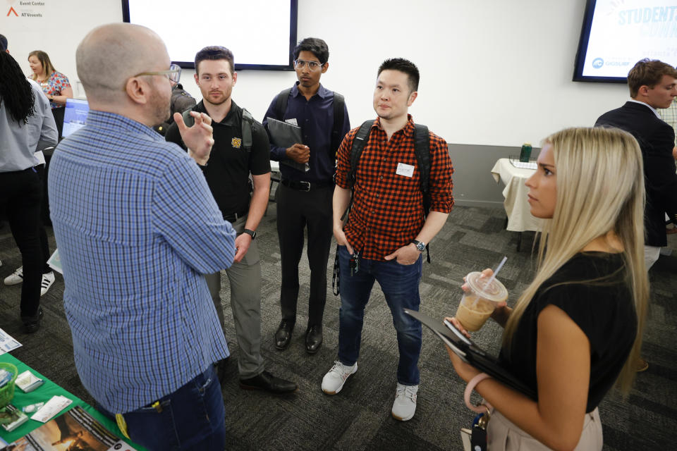 College students speak with representatives of local tech companies during the Startup Student Connection job fair, Wednesday, March 29, 2023, in Atlanta. For the thousands of workers who'd never experienced upheaval in the tech sector, the recent mass layoffs at companies like Google, Microsoft, Amazon and Meta came as a shock. Now they are being courted by long-established employers whose names aren't typically synonymous with tech work, including hotel chains, retailers, investment firms, railroad companies and even the Internal Revenue Service. (AP Photo/Alex Slizt)