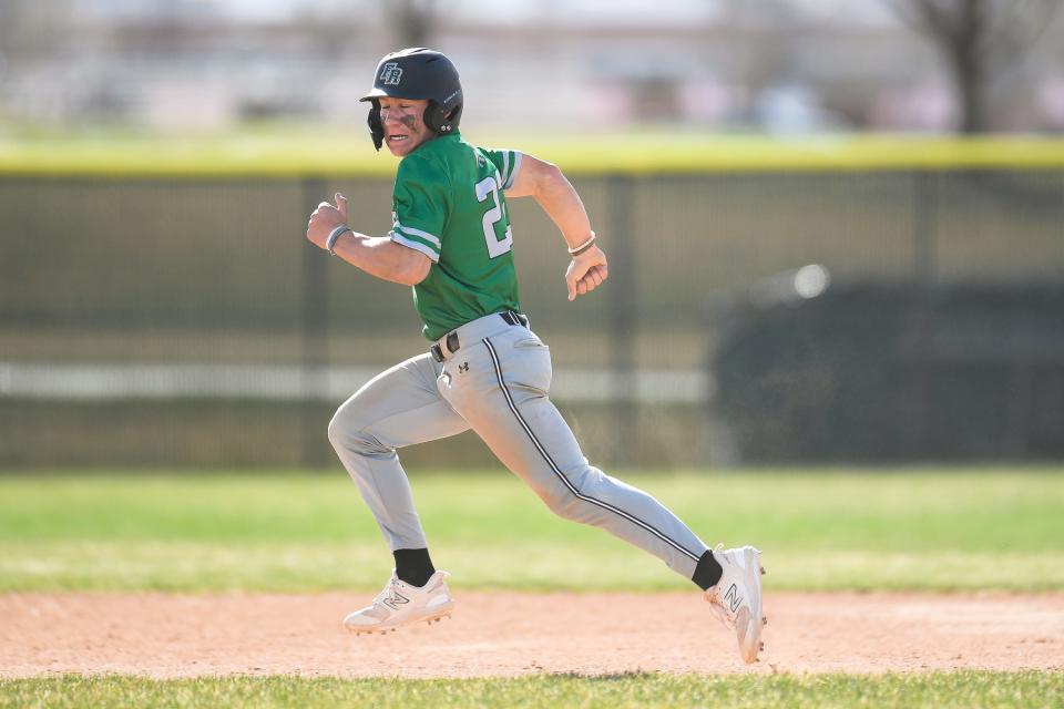 Fossil Ridge's Owen Morgan (22) sprints to second base during a high school baseball game against Fort Collins at Fort Collins High School on April 18, 2023.