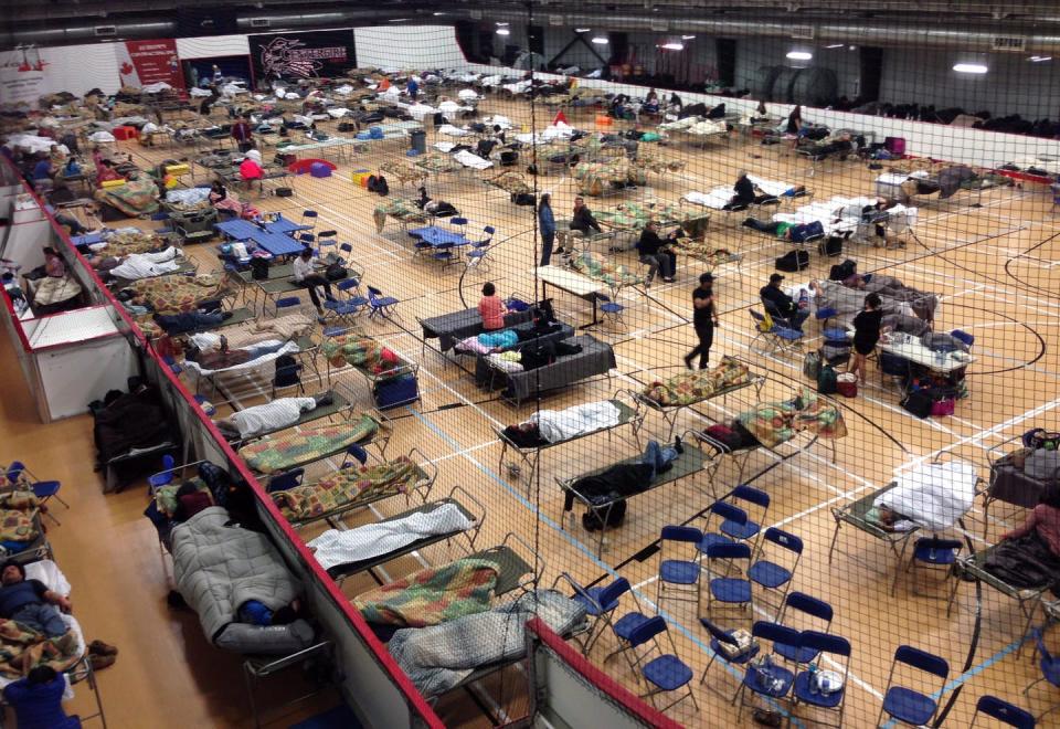 Cots litter the gym floor at a reception centre set up for evacuees from Fort McMurray, Alta when the city was evacuated during a wildfire in 2016. THE CANADIAN PRESS/Greg Halinda