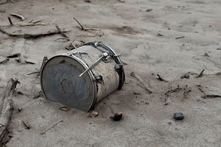 A drum covered with ash lies outside a house affected by the eruption of the Fuego volcano at San Miguel Los Lotes in Escuintla, Guatemala, June 6, 2018. REUTERS/Carlos Jasso