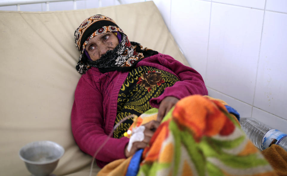 FILE - In this Thursday, March 28, 2019 file photo, an elderly woman is treated for suspected cholera infection at a hospital in Sanaa, Yemen. Cholera is surging once more in Yemen, with more than 76,000 suspected new cases and 195 deaths in March, double the number in the previous two months, according to U.N. figures. Doctors point to the difficulty in controlling epidemics in a country where infrastructure has been decimated by four years of war. (AP Photo/Hani Mohammed, File)