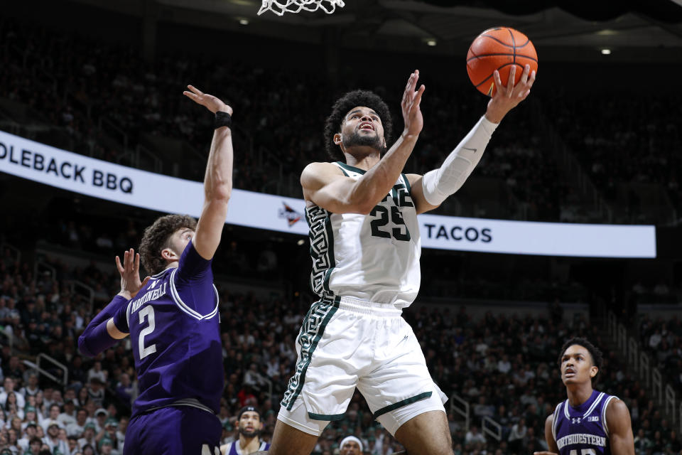 Michigan State forward Malik Hall (25) shoots against Northwestern forward Nick Martinelli (2), left, during the second half of an NCAA college basketball game, Wednesday, March 6, 2024, in East Lansing, Mich. (AP Photo/Al Goldis)