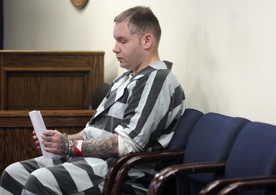 CORRECTS TO JUDGE HAMILTON, NOT COLLINS IN SECOND SENTENCE - Don Willburn Collins waits to be placed into the custody of the Montgomery County Sheriff's Office following a hearing at the 359th Judicial District Court with Judge Kathleen Hamilton on Thursday, March 6, 2014, in Conroe, Texas. Collins, now 28, accused of dousing Robert Middleton with gasoline and setting him on fire in 1998 when he was a teenager, can be tried as an adult for murder after the victim died from his burns nearly 13 years later, Judge Hamilton ruled Thursday. (AP Photo/ The Courier, Jason Fochtman) MANDATORY CREDIT