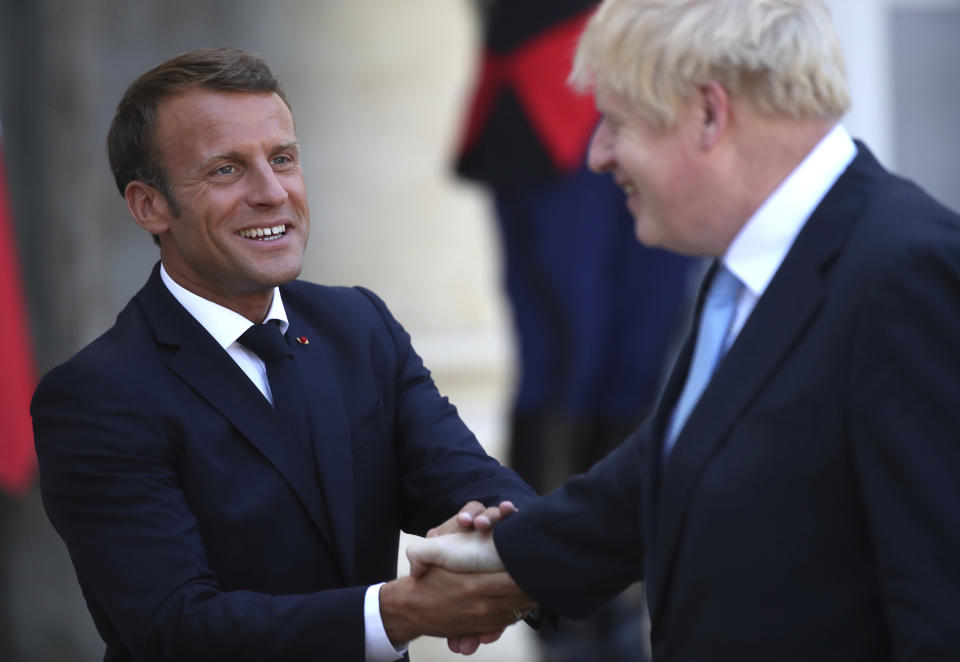 French President Emmanuel Macron bids farewell to Britain's Prime Minister Boris Johnson at the Elysee Palace, Thursday, Aug. 22, 2019 in Paris. Boris Johnson traveled to Berlin Wednesday to meet with Chancellor Angela Merkel before heading to Paris to meet with French President Emmanuel Macron. (AP Photo/Daniel Cole)