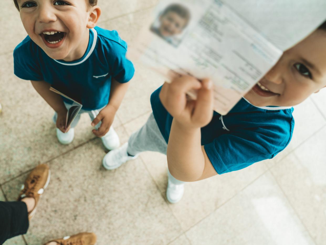 Children holding passport at the airport