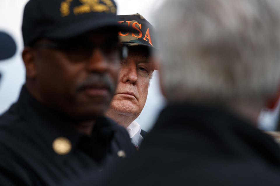 President Donald Trump listens as he visits a neighborhood impacted by the Woolsey Fire, Saturday, Nov. 17, 2018, in Malibu, Calif. (AP Photo/Evan Vucci)