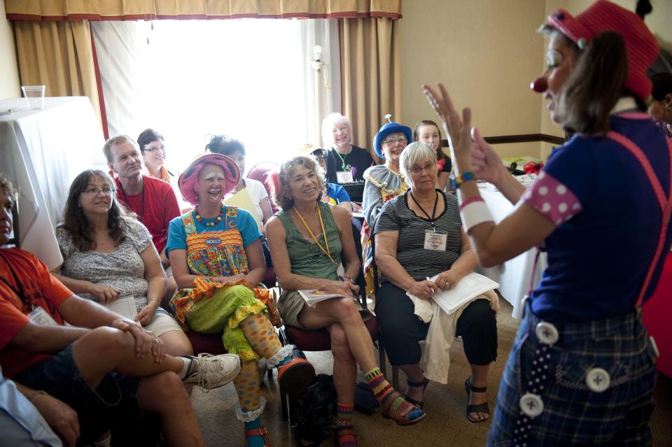 In a July 31, 2012 photo, Julie Varholdt, or "Lovely Buttons" the clown, teaches a course on how clowns can entertain with everyday objects in a pinch at the third annual Clown Campin' in Ontario, Calif. The week-long event is held for clowns across the United States and Canada to learn, get inspired, and network. (AP Photo/Grant Hindsley)