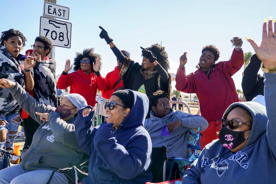 Spectators cheer for performers during the Martin Luther King Jr. Day Parade in Riviera Beach, Florida on January 14, 2023. 
