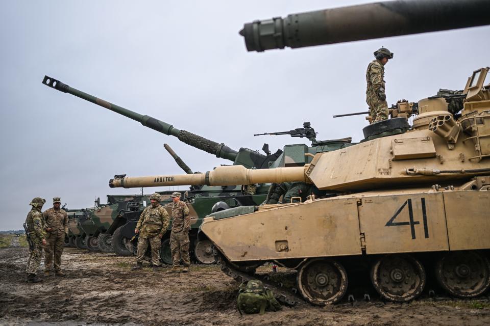 American military stand in front of a Abrams tank before a live fire demonstration part of the Bear 22 military exercises at the Nowa Deba training ground on September 21, 2022, in Nowa Deba, Poland.