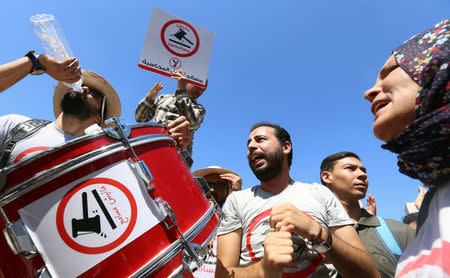 People demonstrate against a bill that would protect from prosecution those accused of corruption, in front of Assembly of the Representatives of the People in Tunis, Tunisia September 13, 2017. The sign reads: "No. We will not forgive". REUTERS/Zoubeir Souissi