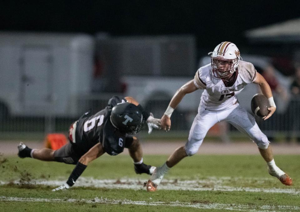 Quarterback Wyatt Scruggs (17) slips past Nathan Shimek (6) before passing to Joe Wright (9) for a touchdown to cut the Aggies lead to 35-6 during the Northview vs Tate football game at Tate High School in Cantonment on Thursday, Sept. 7, 2023.