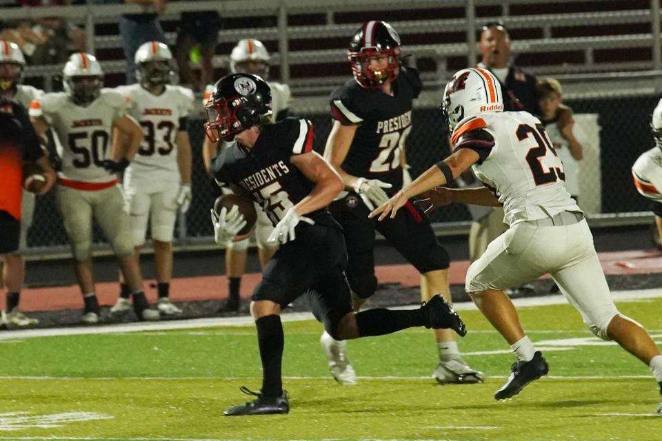 Marion Harding's Parker Davis runs the football during the Week 1 high school football opener against Mount Vernon Friday night at Harding Stadium.