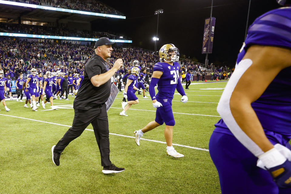 Sep 17, 2022; Seattle, Washington, USA; Washington Huskies head coach Kalen DeBoer runs on to the field with players following a 39-28 victory against the Michigan State Spartans at Alaska Airlines Field at Husky Stadium. Mandatory Credit: Joe Nicholson-USA TODAY Sports