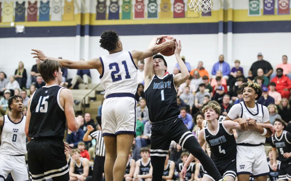 North Oldham's Dallas Roberts fights for a rebound with Warren Central's Chappelle Whitney in Monday's semifinal King of the Bluegrass in Fairdale. Roberts finished with 22 points but the Mustangs fell 71-57. Dec. 19, 2022 