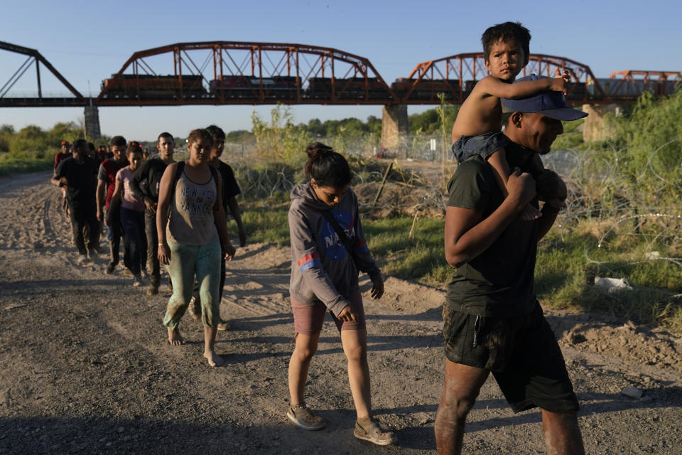 Migrants who crossed the Rio Grande and entered the U.S. from Mexico head to be processed by U.S. Customs and Border Protection, Saturday, Sept. 23, 2023, in Eagle Pass, Texas. (AP Photo/Eric Gay)