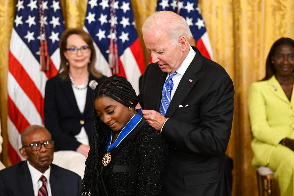 President Joe Biden presents gymnast Simone Biles with the Presidential Medal of Freedom in the East Room of the White House on July 7, 2022. (Saul Loeb / AFP - Getty Images)