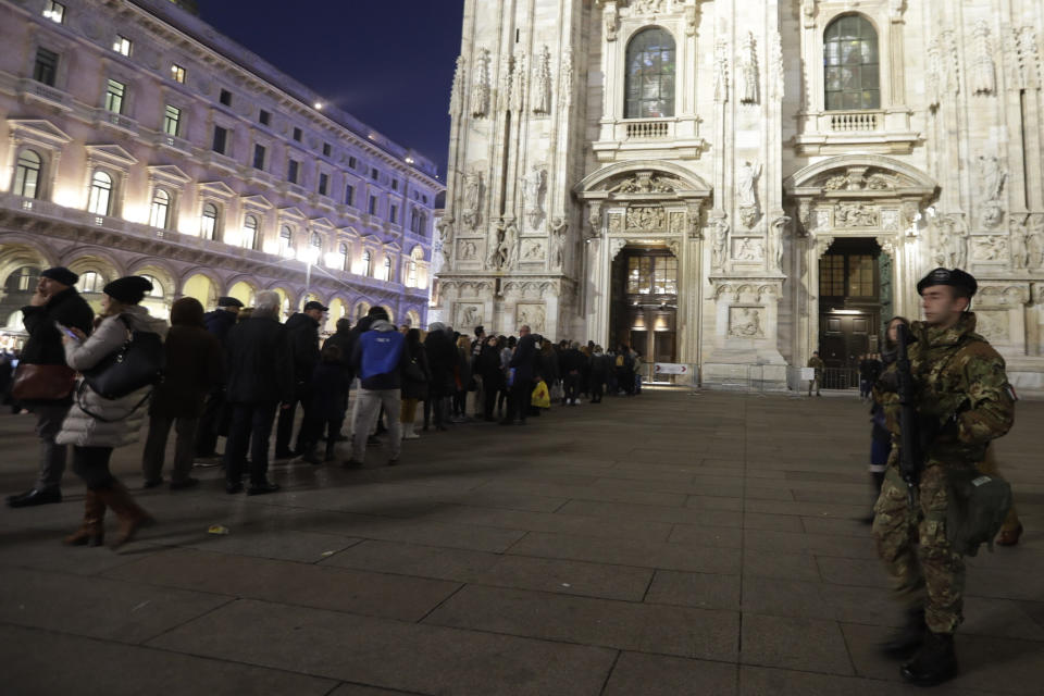 Tourists line up for security checks performed by Italian Soldiers to enter the Duomo gothic cathedral in Milan, Italy, Wednesday, Dec. 23, 2016. The Tunisian man suspected of driving a truck into a crowded Christmas market in Berlin was killed early Friday in a shootout with police in Milan, ending a Europe-wide manhunt, Italy’s interior minister said. (AP Photo/Luca Bruno)