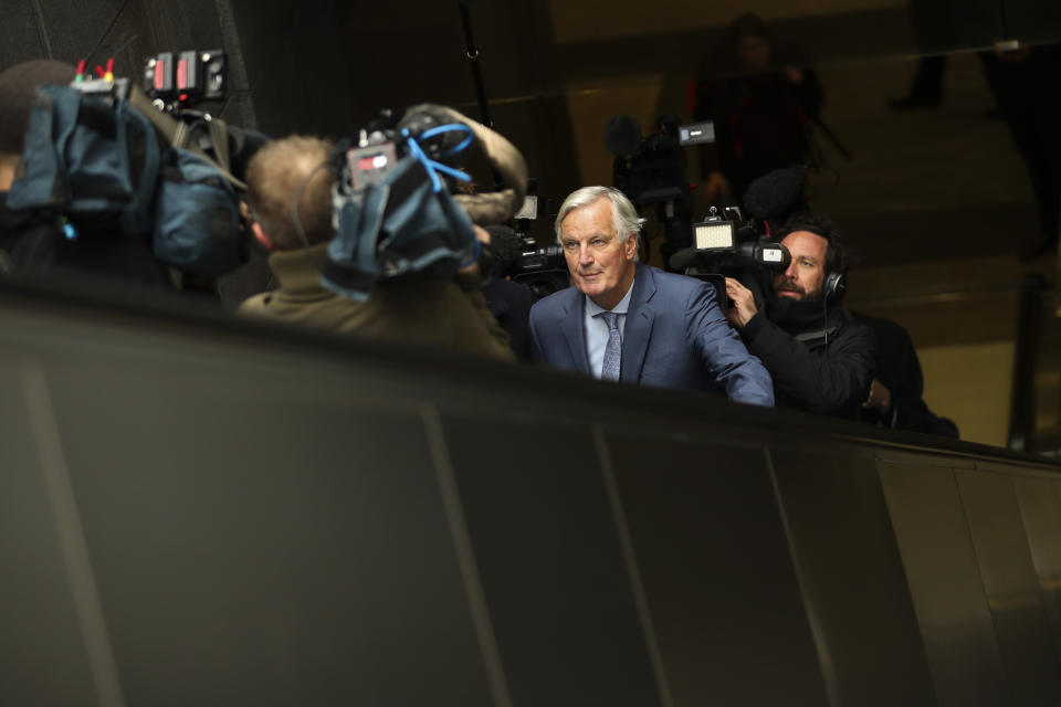 European Union chief Brexit negotiator Michel Barnier, front, rides an escalator surrounded by the media on his way to a meeting at the Europa building in Brussels, Friday, Oct. 11, 2019. EU negotiator Michel Barnier says that he had a "constructive meeting" with British Brexit envoy Stephen Barclay and underscored the cautious optimism since Thursday's meeting between British Prime Minister Boris Johnson and his Irish counterpart Leo Varadkar. (AP Photo/Francisco Seco)