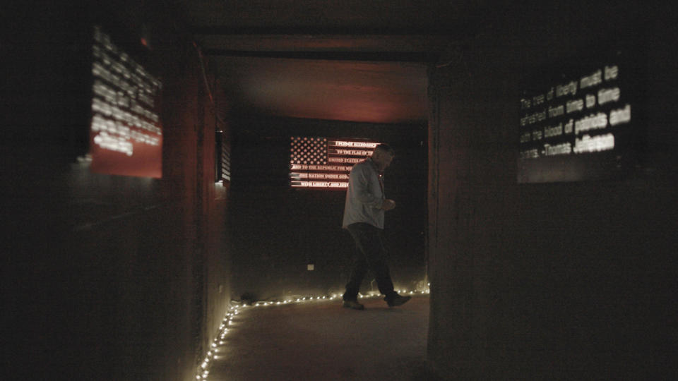 Owner Victor Mellor, Sr., walks through an entrance hallway at The Hollow in Venice, Fla., on Aug. 1, 2022. Mellor said members of the violent extremist group the Proud Boys had volunteered at the Hollow before he knew they were members of the group, but said they were welcome, calling them “just dads and husbands.” (Richard Rowley/Frontline via AP)