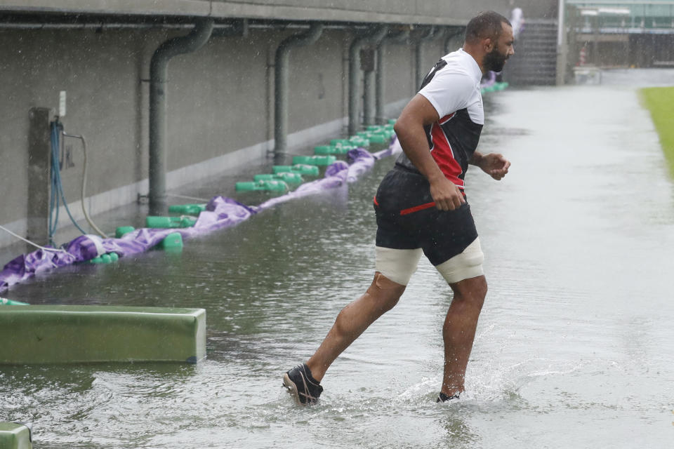 Japan team's Michael Leitch works out, ahead of their Rugby World Cup Pool A match against Scotland as Typhoon Hagibis approaches Saturday, Oct. 12, 2019 in Tokyo. (Kyodo News via AP)