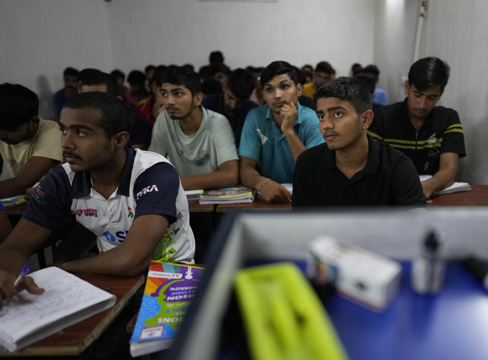 Indian youth aspiring to join the military attend classes at the Malik Defence academy in Rohtak, India, July 18, 2022. As factory and private sector employment shrink, young jobseekers increasingly are targeting government jobs, coveted for their security, prestige and benefits. In June, the Indian government overhauled military recruitment to cut costs and modernize, changing long-term postings into four-year contracts after which only 25% of recruits will be retained. (AP Photo/Manish Swarup)