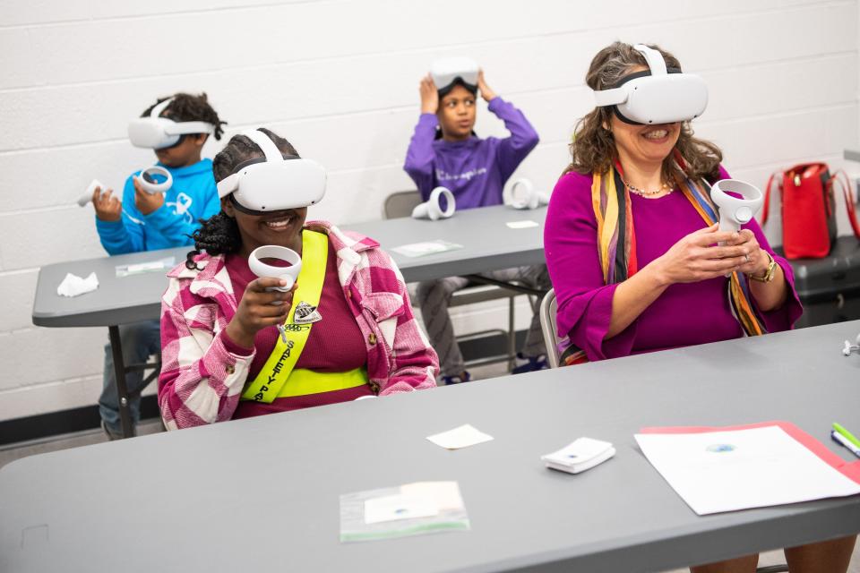 Knoxville Mayor Indya Kincannon, right, and children participating in an after-school program try out an Oculus virtual reality headset.