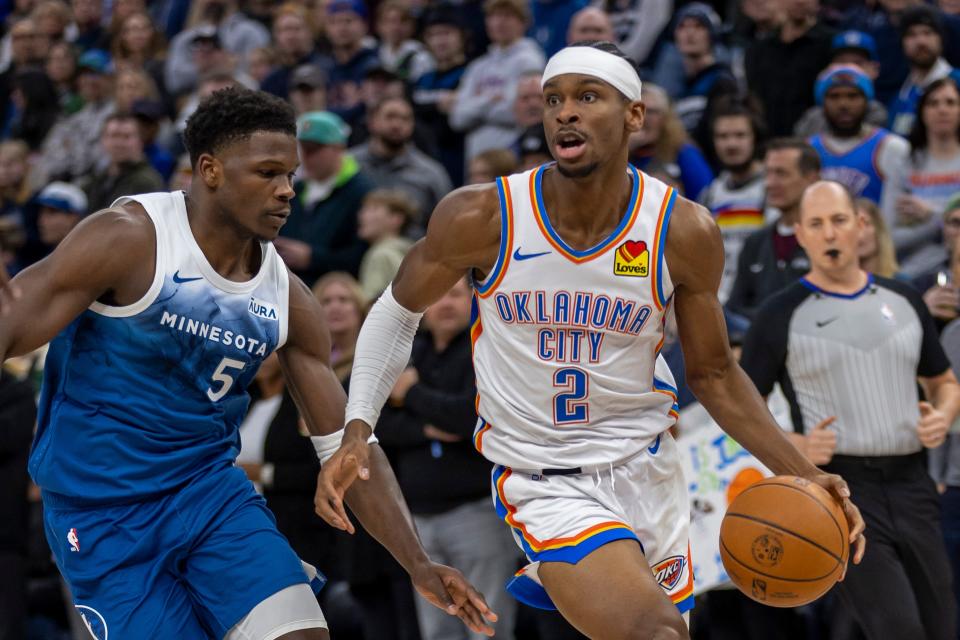 Jan 20, 2024; Minneapolis, Minnesota, USA; Oklahoma City Thunder guard Shai Gilgeous-Alexander (2) dribbles the ball around Minnesota Timberwolves guard Anthony Edwards (5) in the first half at Target Center. Mandatory Credit: Jesse Johnson-USA TODAY Sports