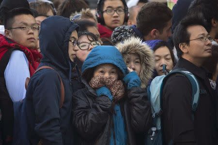 Customers await with hundreds of others to purchase iPhone 6 on the first day of sales outside the Fifth Avenue Apple store in Manhattan, New York September 19, 2014. REUTERS/Adrees Latif