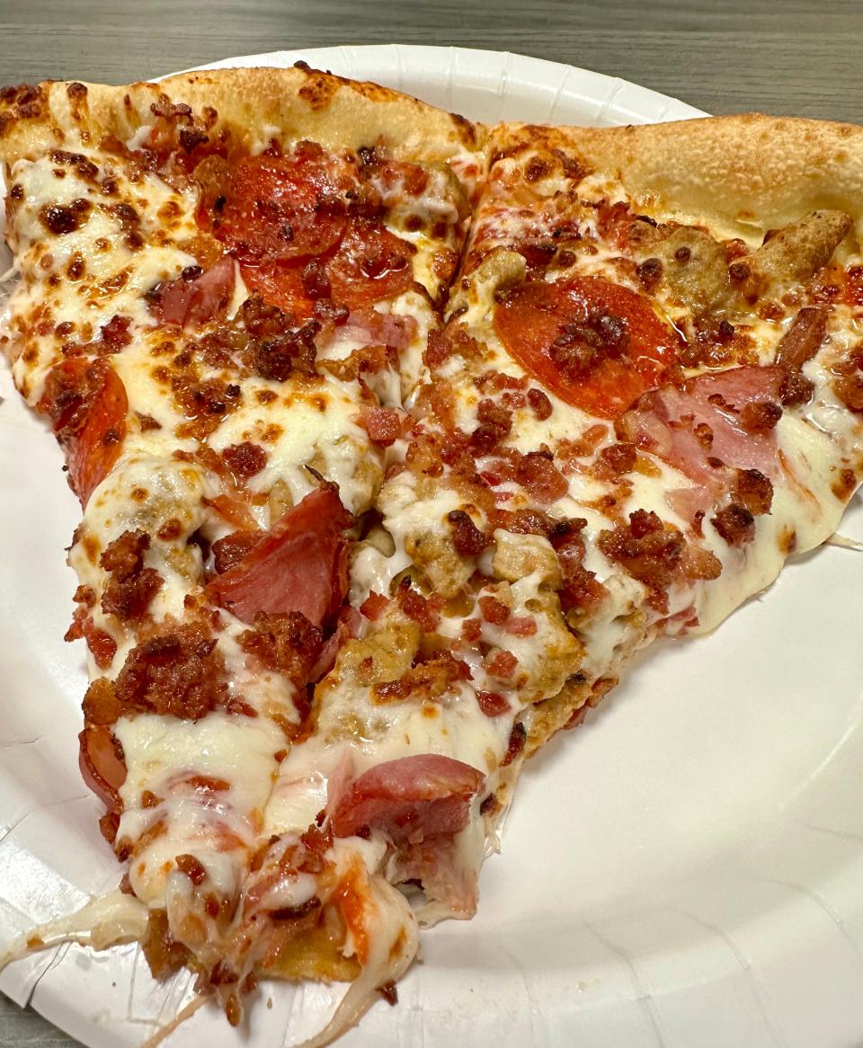 Two slices of meat pizza (ham, pepperoni, Italian sausage and bacon) are part of the pizza combo at Sam's Club food court in Jackson Township.